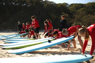 A group of groms getting ready to head out on the water