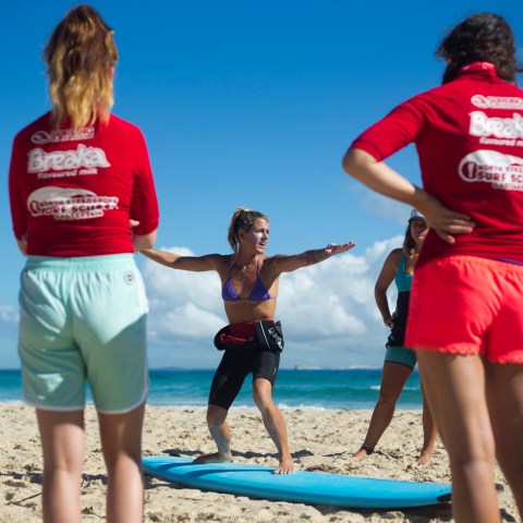 A instructor giving two groms lessons on balance