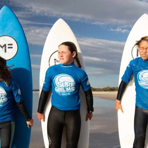 Two groms posing with their surfboards
